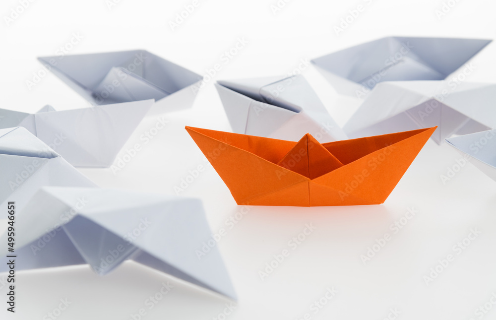 Orange paper boat and a lot of sinking ships Orange paper boat and a lot of sinking ships