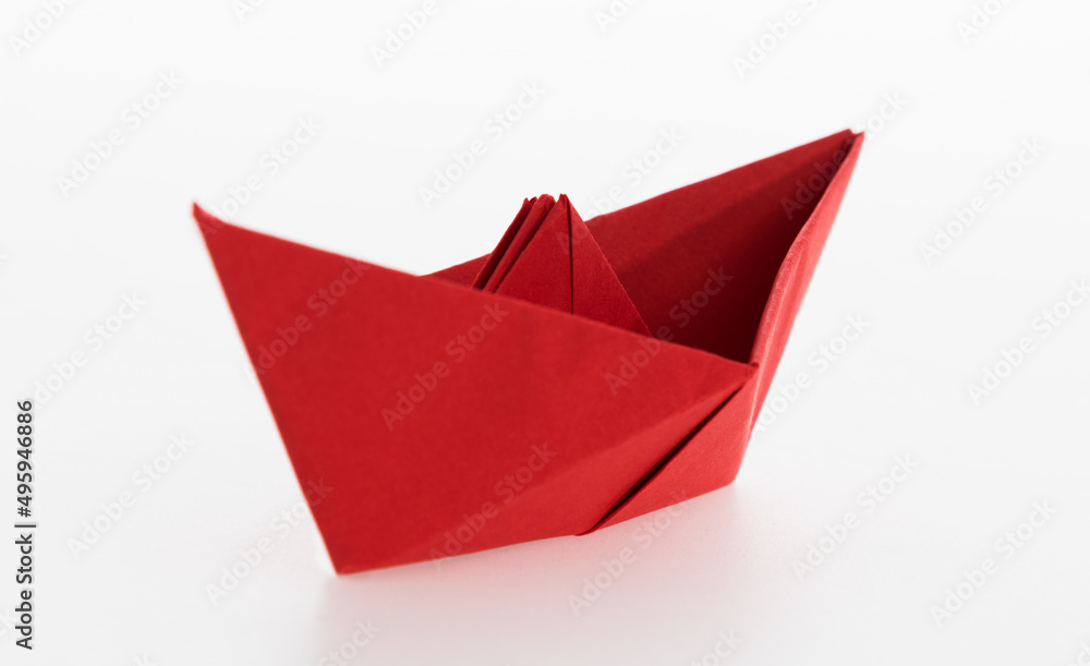 Red origami boat on white background Red origami boat on white background