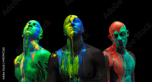 Colorful collage. Male body and face covered with multicolored paints isolated over black background.