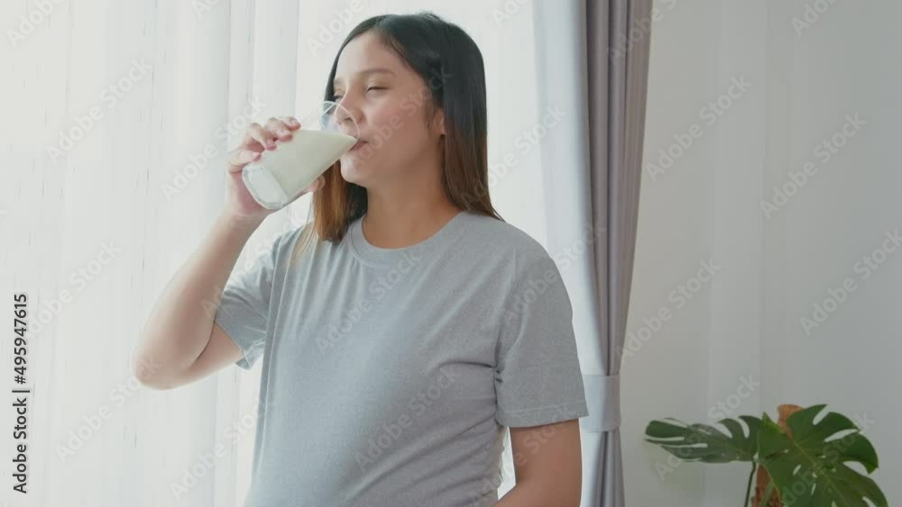 Young pregnant woman drinking milk at home, healthcare and pregnancy care Young pregnant woman drinking milk at home, healthcare and pregnancy care