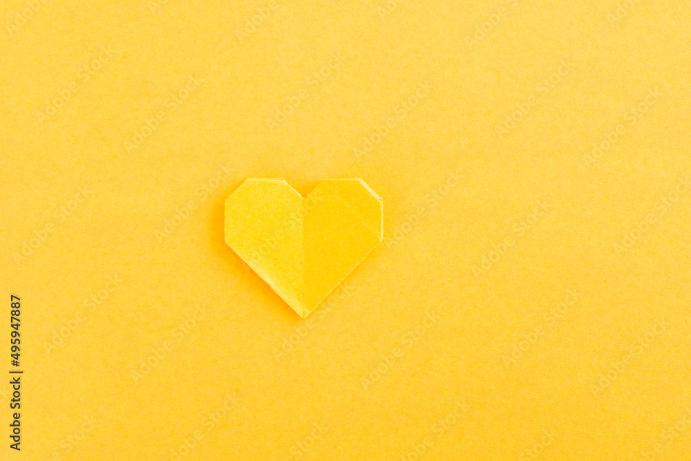 Yellow origami heart on yellow background Yellow origami heart on yellow background