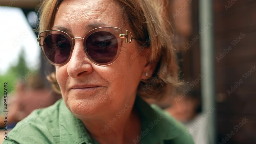 Portrait of an older woman wearing stylish sunglasses Portrait of an older woman wearing stylish sunglasses