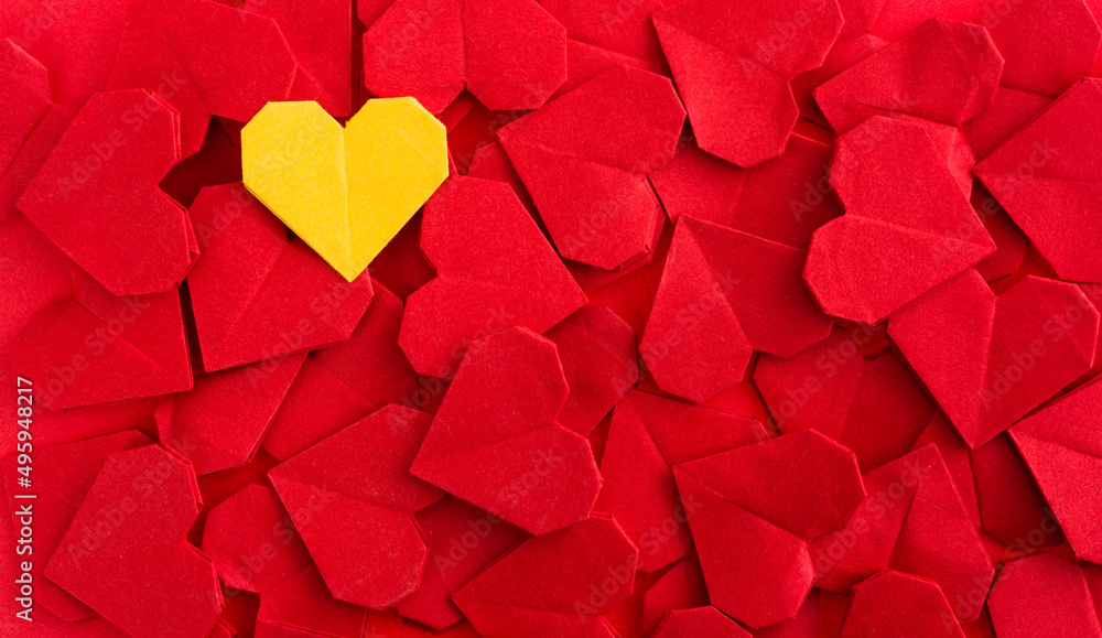 Yellow origami heart on red origami hearts Yellow origami heart on red origami hearts