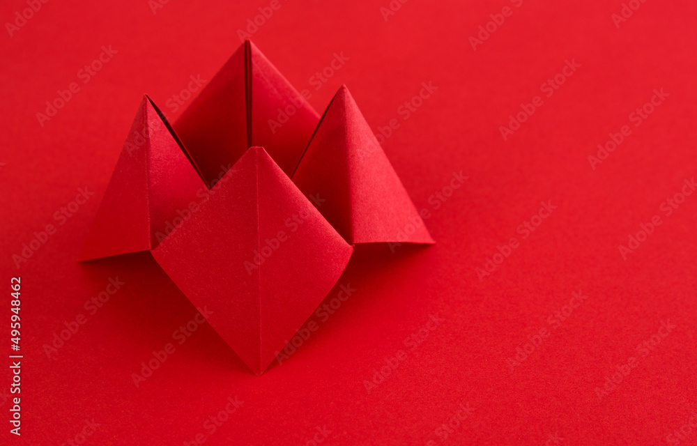 Obraz premium Origami paper fortune on red background