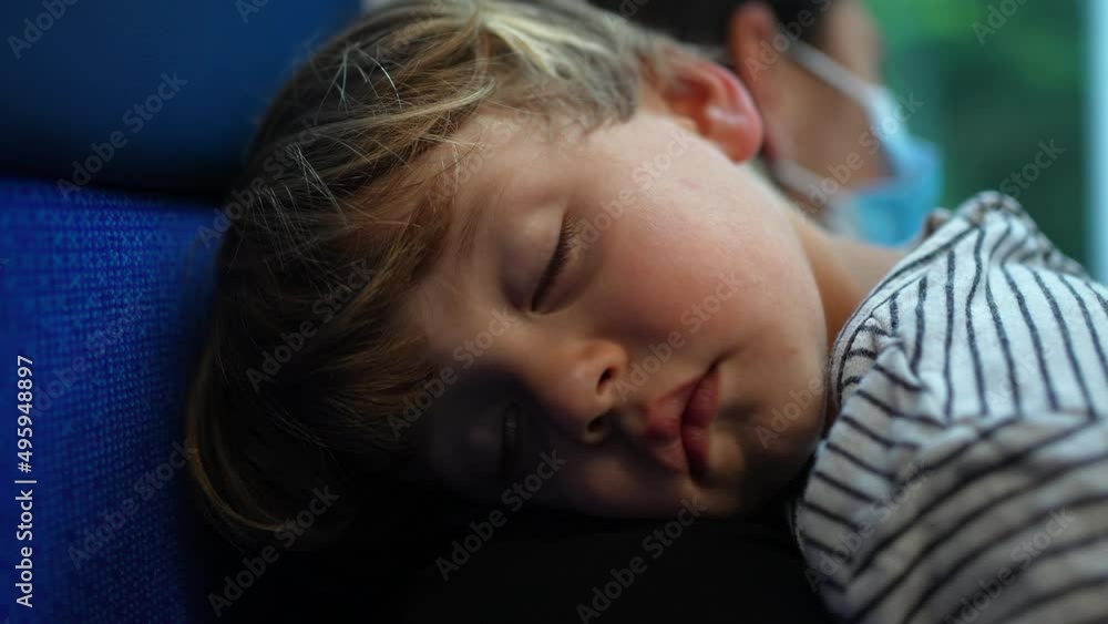 Small boy asleep on mother arms traveling by train child napping Small boy asleep on mother arms traveling by train child napping