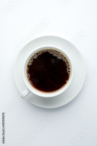 Coffee filter in a white porcelain cup with a saucer on a white background