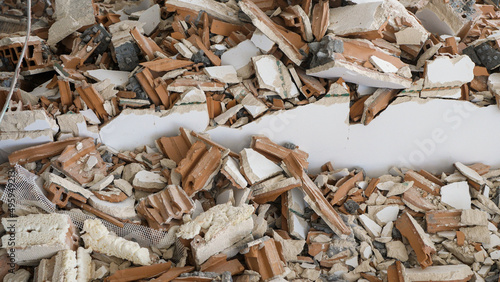 Pile of construction waste after wall demolition in an apartment during remodeling