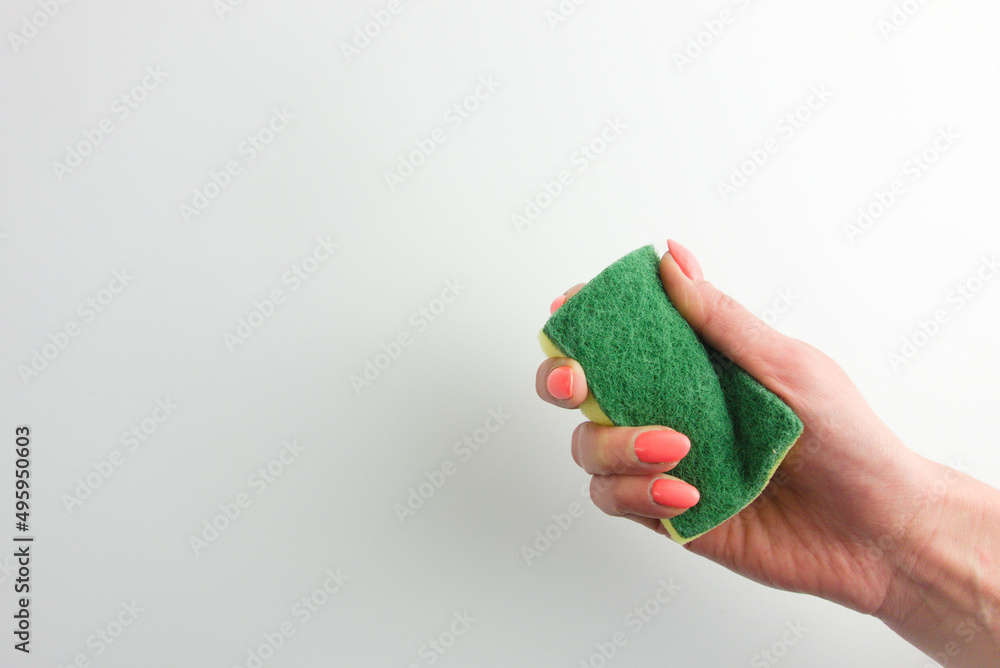 Woman hand holding a cleaning sponge. Domestic hygiene, housework concepts. Empty space for your design Woman hand holding a cleaning sponge. Domestic hygiene, housework concepts. Empty space for your design