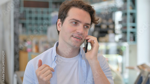 Busy Young Man Talking on Phone