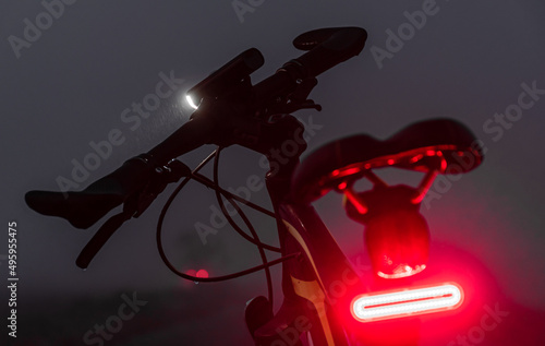 Bike with lights turned on in the dark fog.