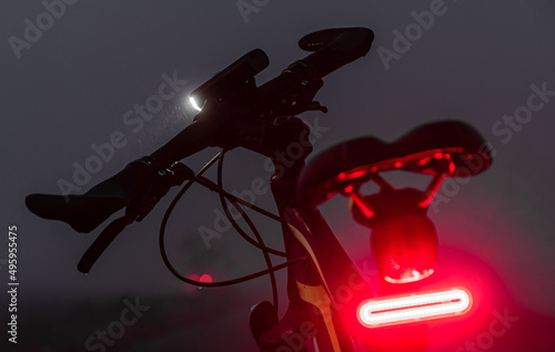 Bike with lights turned on in the dark fog. photo