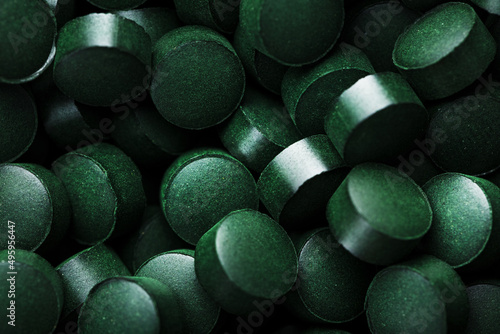 Green tablets from spirulina vegetarian dietary supplement photo