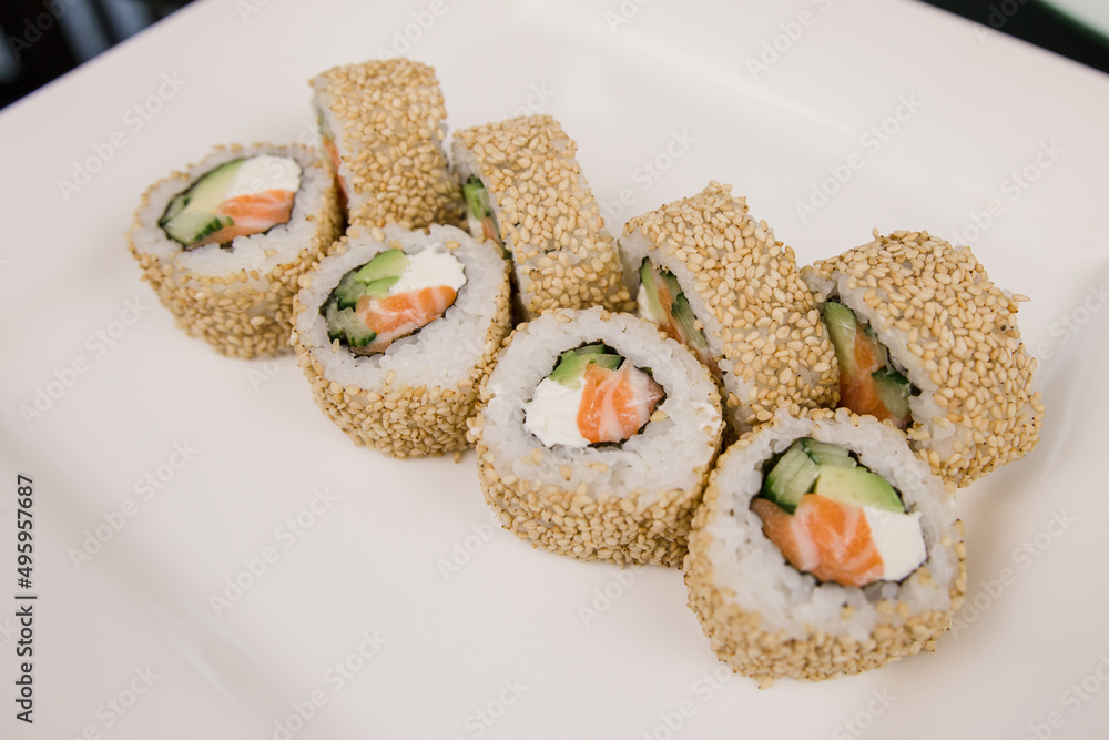 Philadelphia roll with salmon in sesame and white rice Philadelphia roll with salmon in sesame and white rice