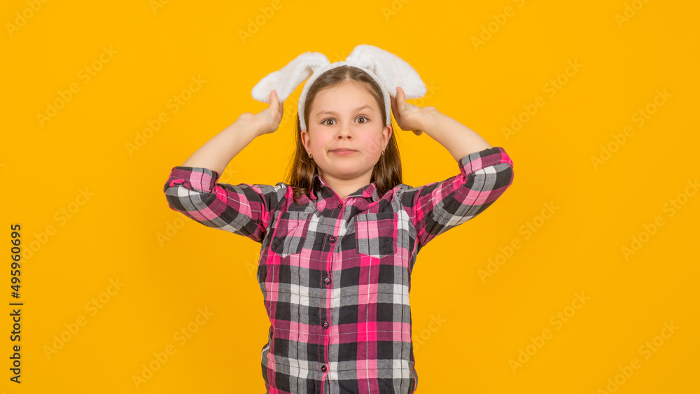 easter girl in bunny ears on yellow background easter girl in bunny ears on yellow background