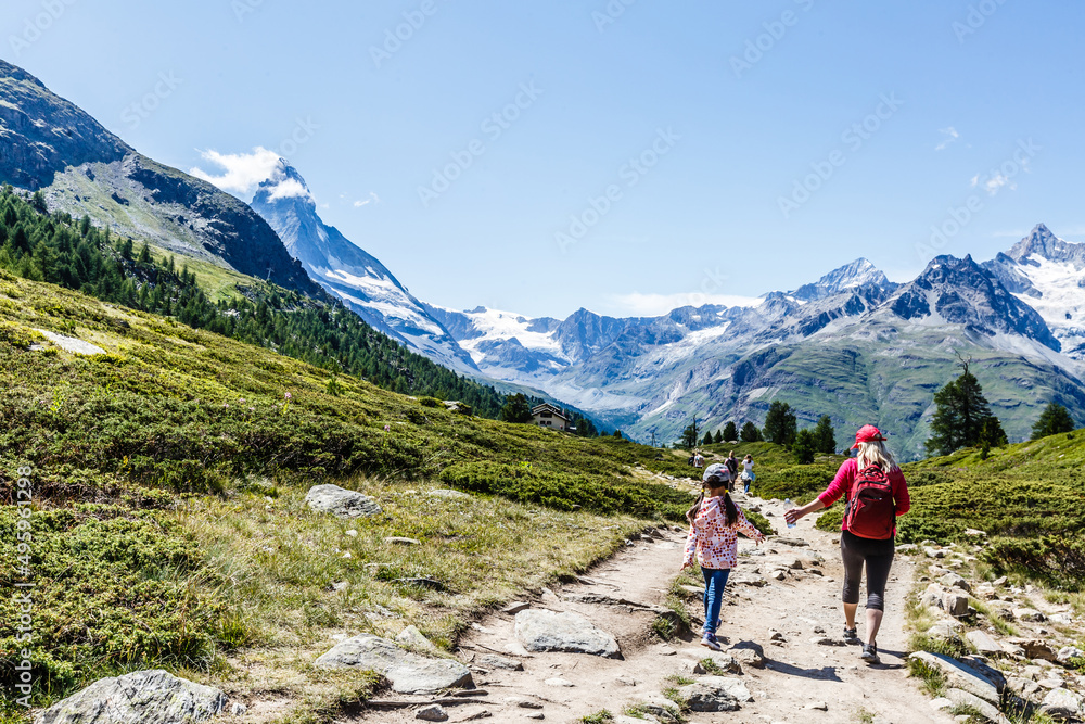 Mother and children going for a walk in mountain surroundings.