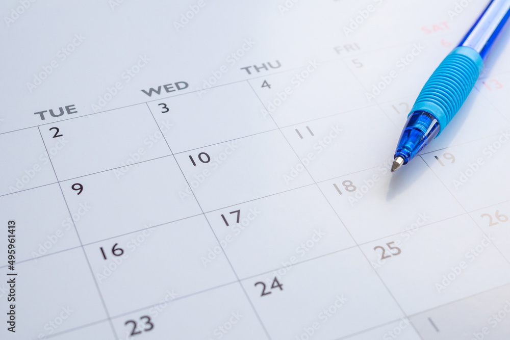 Blue pen on calendar page background business planning appointment meeting concept Blue pen on calendar page background business planning appointment meeting concept