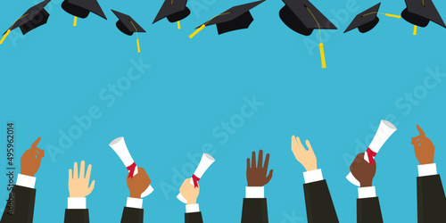 Graduating students hands in gown throwing graduation caps in the air holding degrees