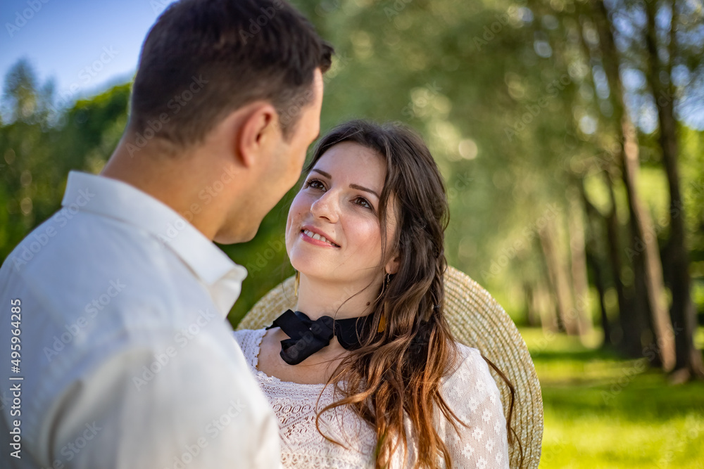 Happy young people in wedding dresses stand in the meadow and look at each other. portrait of a bride looking at her lover Happy young people in wedding dresses stand in the meadow and look at each other. portrait of a bride looking at her lover