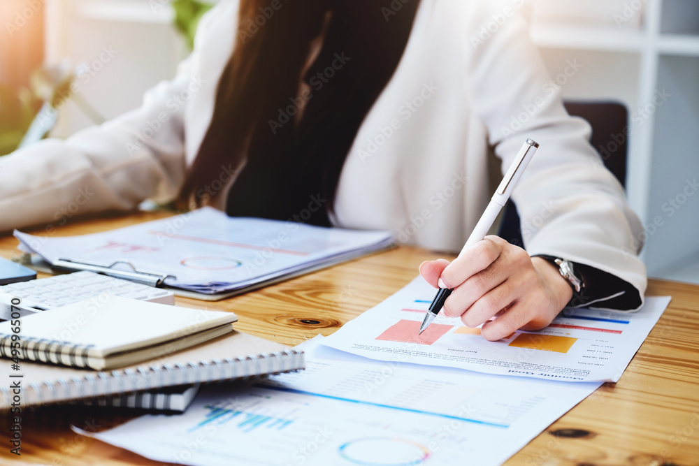 Investment concepts, businesswomen use document and computers to analyze stock markets, quantitative data collection, financial statement analysis, profitability through internet technology. Investment concepts, businesswomen use document and computers to analyze stock markets, quantitative data collection, financial statement analysis, profitability through internet technology.