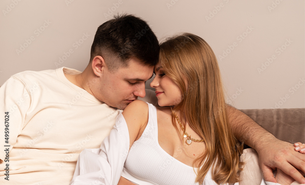 Man kissing shoulder of woman. Love couple at home. Passion and tenderness. High quality photo