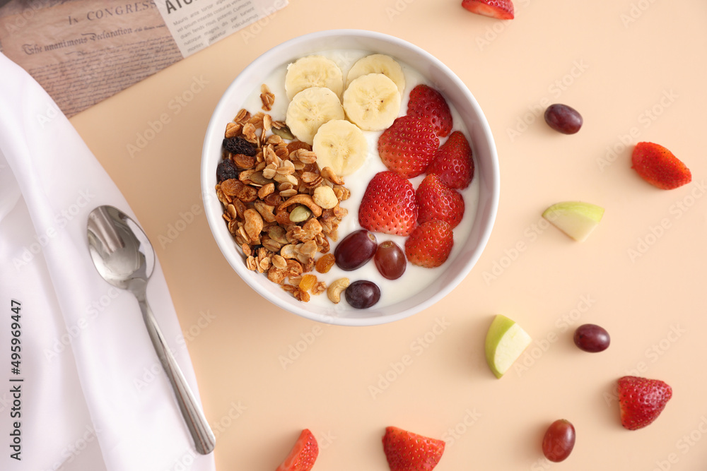 bowl of granola cereal with yogurt and berries isolated on eggnog color background bowl of granola cereal with yogurt and berries isolated on eggnog color background