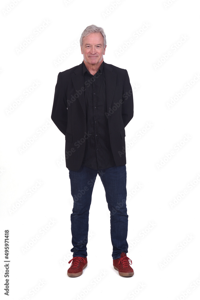 front view of man dressed in jeans sneakers and blazer with hands on back on white background front view of man dressed in jeans sneakers and blazer with hands on back on white background