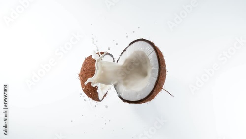 Cracked coconut with splashing milk, super slow motion filmed on high speed cinematic camera at 1000 fps. photo