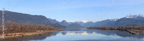 Early winter scenery with a river and snow-capped mountains