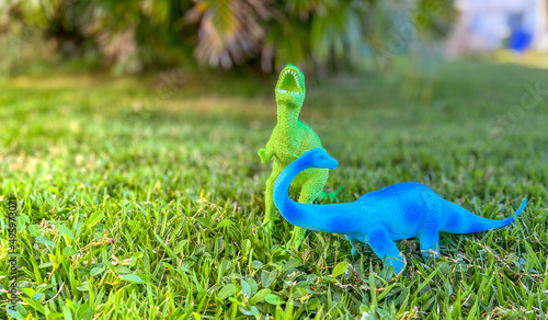 toy dinosaurs on the grass. free space for text