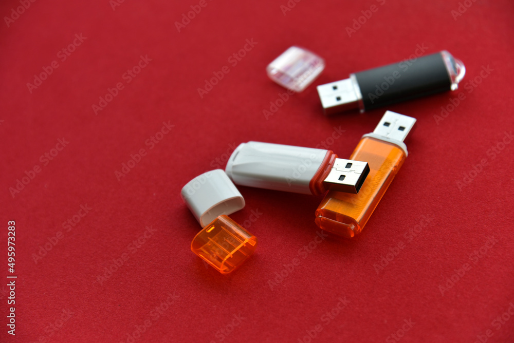 Various USB flash drives on a red background Various USB flash drives on a red background
