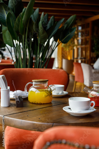 teapot with tea on a wooden table in a premium restaurant 