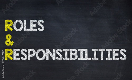 Roles and responsibility - R&R acronym written on chalkboard, business acronyms.