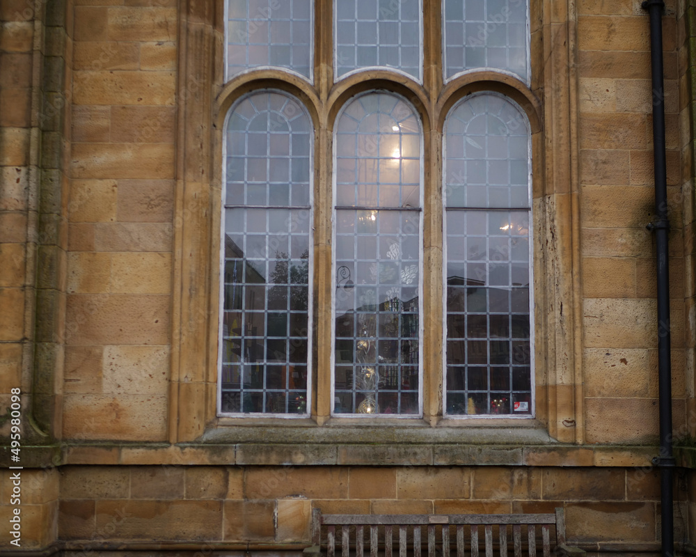Traditional old leaded window in stone build English church window Traditional old leaded window in stone build English church window
