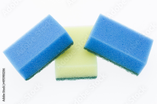 Photo of a yellow and two blue scouring pads against a white background
