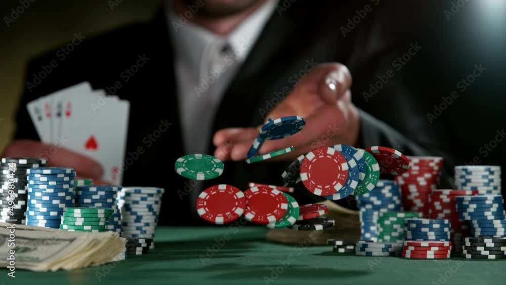 Poker player throwing poker chips on casino table in super slow motion, filmed on high speed cinema camera at 1000 fps. Gambling background. Poker player throwing poker chips on casino table in super slow motion, filmed on high speed cinema camera at 1000 fps. Gambling background.