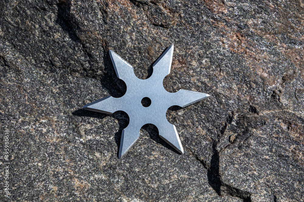 Shuriken (throwing star), traditional japanese ninja cold weapon stuck Shuriken (throwing star), traditional japanese ninja cold weapon stuck