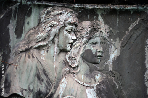 An old, and extremely weathered sandstone relief which shows an elder sister who reassuring her younger sister. © Frank Middendorf