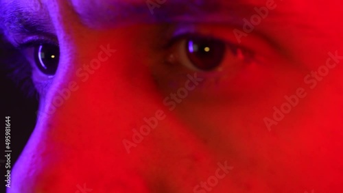 Macro shot of male eye on neon light, Determined businessman or student's strong look man