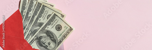 dollars in envelope on pink backlground.Stop corruption, bribery concepts. Giving money or bribe for signing agreement. Symbol of anti-corruption movement, lobbying, extortion and nepotism. Copy space photo