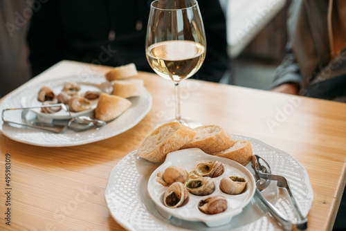 french snail dish with a glass of wine