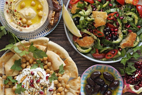 Traditional Lebanese dishes assortment. Chickpea Fatteh, Tabbouleh, Fattoush Salad, Hummus and various of appetizers. Flat layot, selective focus