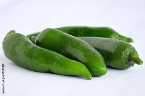 green chili pepper. Serrano peppers isolated on a white background. Jalapeno peppers. Hot and spicy ingredient for food. Agricultural peppers 