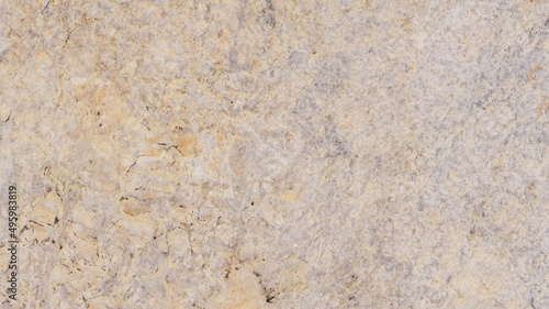 Beige stone texture with spots and cracks. Cracked vintage wall background