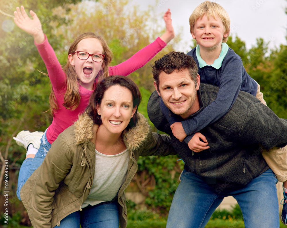 We love family weekends. Portrait of a young family standing outside together. We love family weekends. Portrait of a young family standing outside together.