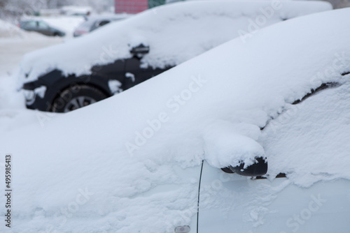 the cars on the parking under snow