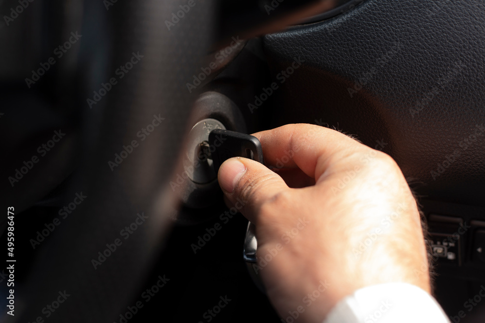 Close-up Of Person's Hand Inserting Key To Start Car