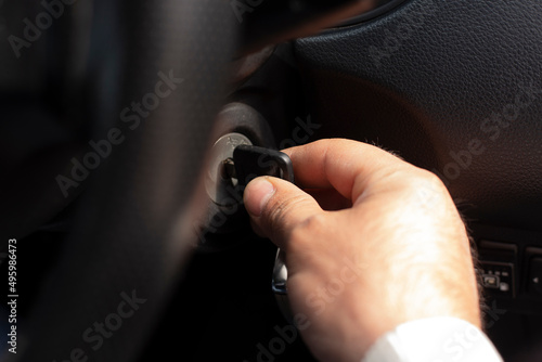 Close-up Of Person's Hand Inserting Key To Start Car