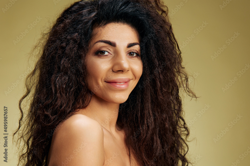 BEAUTY FASHION CONCEPT. Sexy smiling pensive beautiful tanned awesome curly Latin lady posing isolated on pastel olive green background look at camera. Cool offer, banner for cosmetic hairstyle brand BEAUTY FASHION CONCEPT. Sexy smiling pensive beautiful tanned awesome curly Latin lady posing isolated on pastel olive green background look at camera. Cool offer, banner for cosmetic hairstyle brand