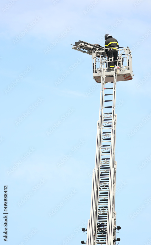 brave firefighter who saves the injured person using the truck with the ladder truck brave firefighter who saves the injured person using the truck with the ladder truck