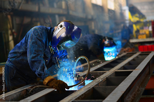 A welder works at a factory	
